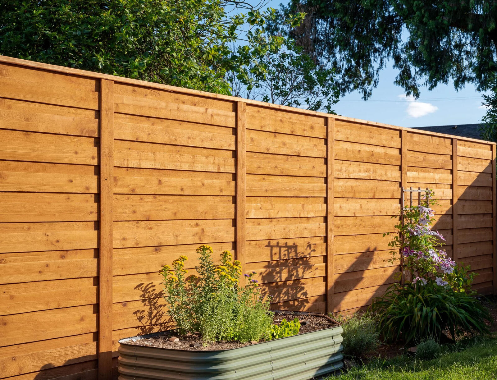 Horizontal cedar wood privacy fence in a Conroe TX garden